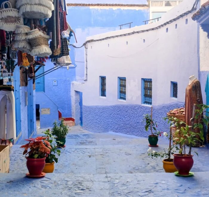 Blue stair alley with flowerpots in Chefchaouen, Morocco