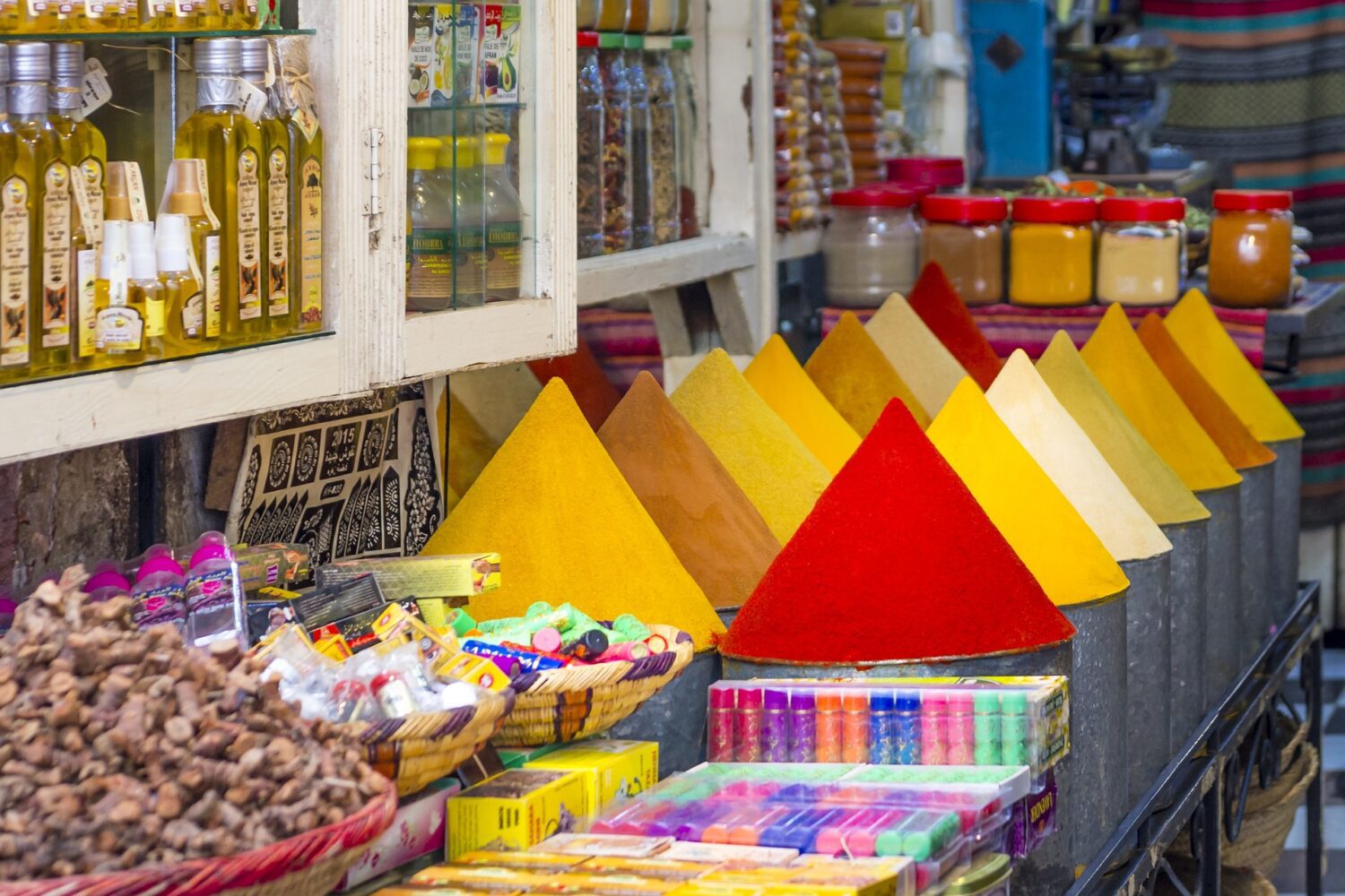 Colorful spice and herbs market stall in Marrakech Medina during a guided tour