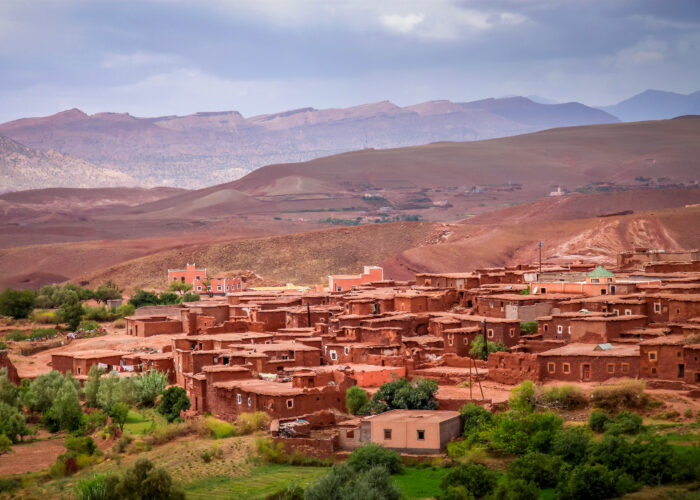Atlas Mountains Morocco Berber village – traditional clay houses and red valley landscape near Marrakech.