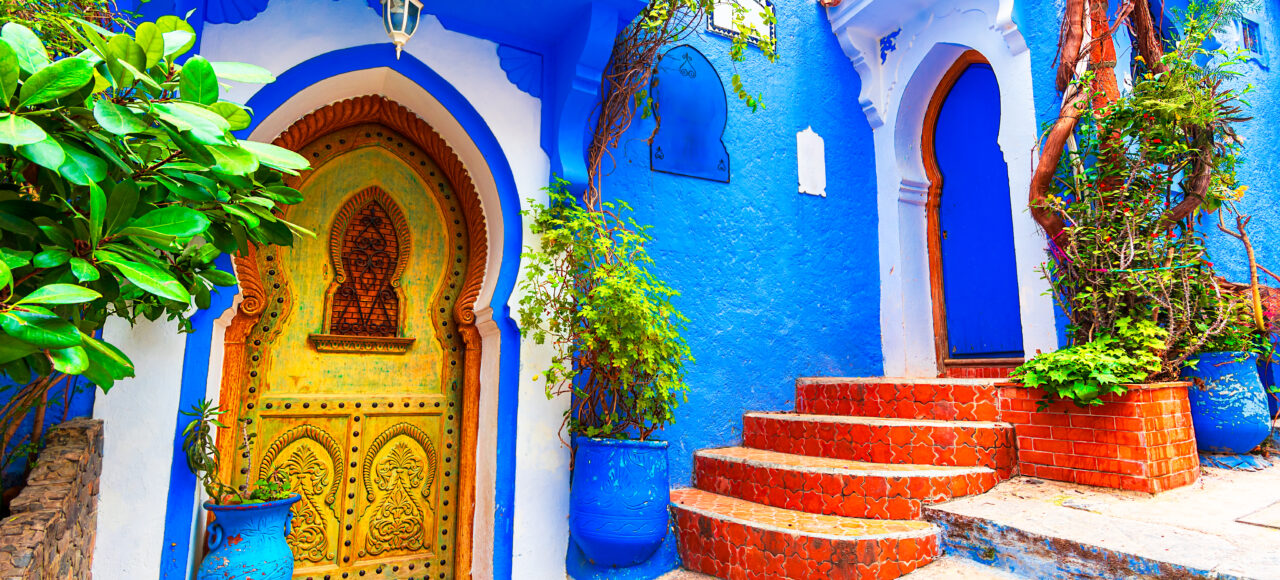 Blue stairs and colorful flower pots in the medina of Chefchaouen, Morocco