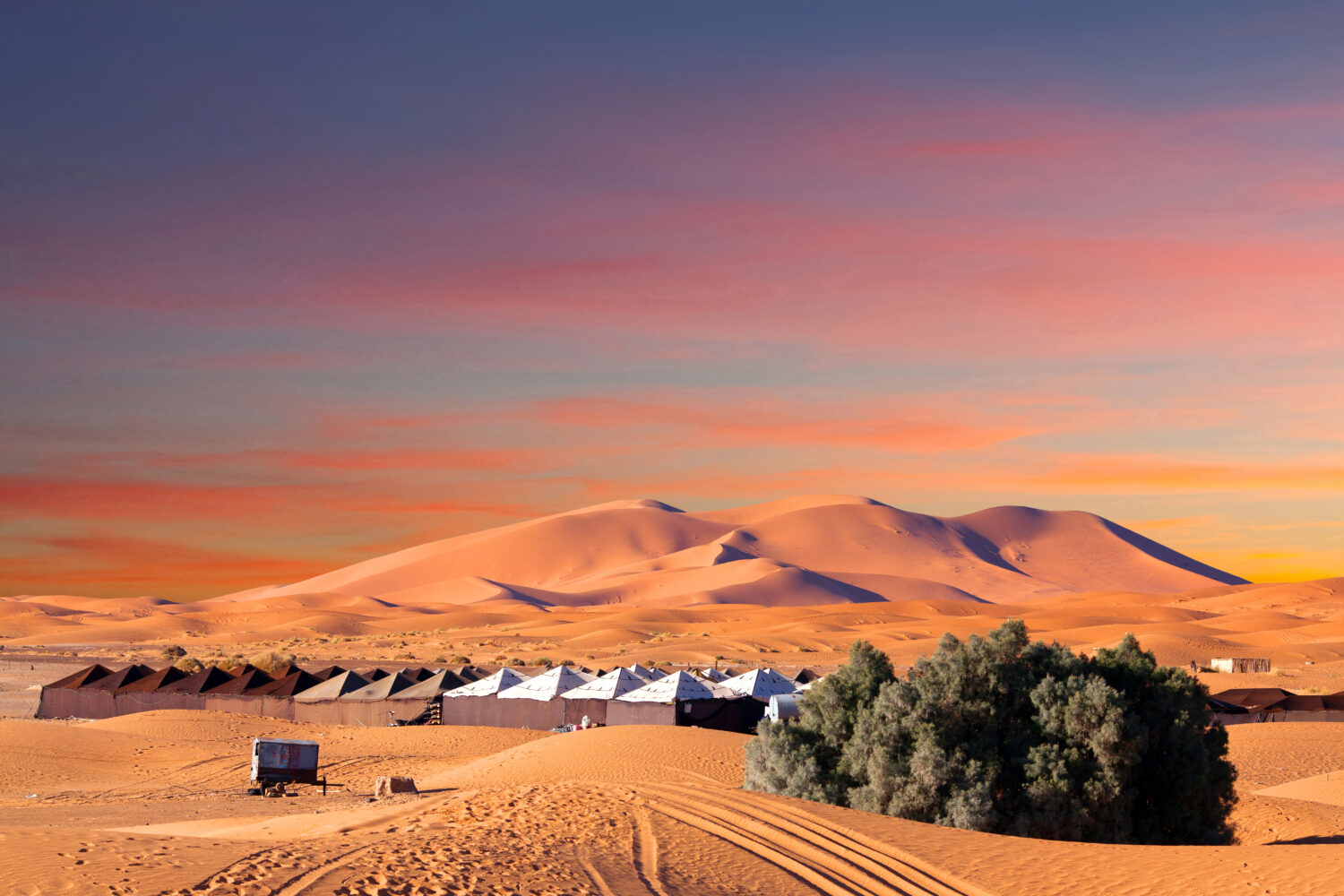 9-Day Imperial Cities & Sahara Tour from Casablanca. Luxury desert camp in Merzouga dunes at sunset