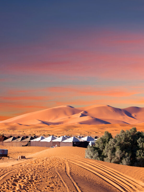 9-Day Imperial Cities & Sahara Tour from Casablanca. Luxury desert camp in Merzouga dunes at sunset