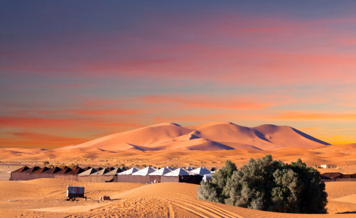 9-Day Imperial Cities & Sahara Tour from Casablanca. Luxury desert camp in Merzouga dunes at sunset