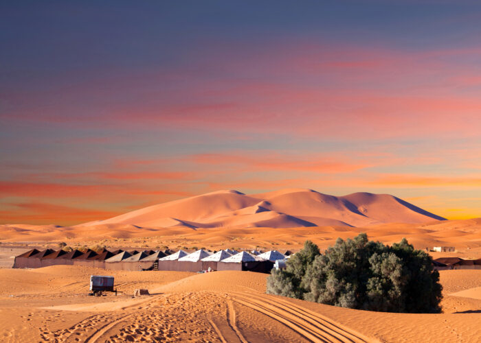 9-Day Imperial Cities & Sahara Tour from Casablanca. Luxury desert camp in Merzouga dunes at sunset