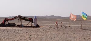 Nomad family in Merzouga Desert with traditional tent