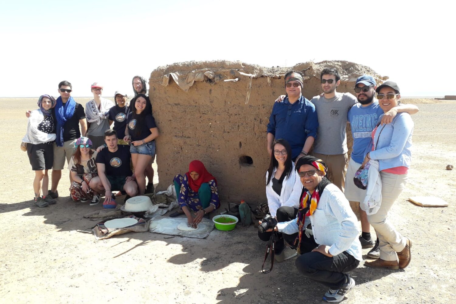 Group of travelers visiting a traditional Berber village in merzouga desert sahara