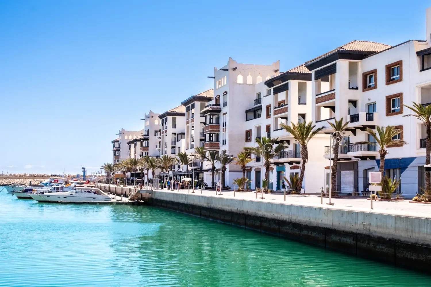 Marrakech to Agadir Private Tour – view of Agadir marina with luxury apartments and boats on Morocco’s Atlantic coast