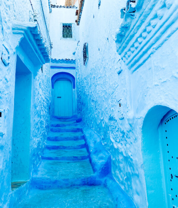9-Day Imperial Cities & Sahara Tour from Casablanca. Blue-painted alley in Chefchaouen, Morocco, showing traditional Moroccan architecture and peaceful atmosphere