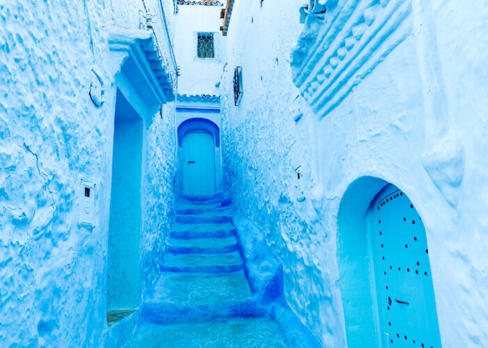 9-Day Imperial Cities & Sahara Tour from Casablanca. Blue-painted alley in Chefchaouen, Morocco, showing traditional Moroccan architecture and peaceful atmosphere