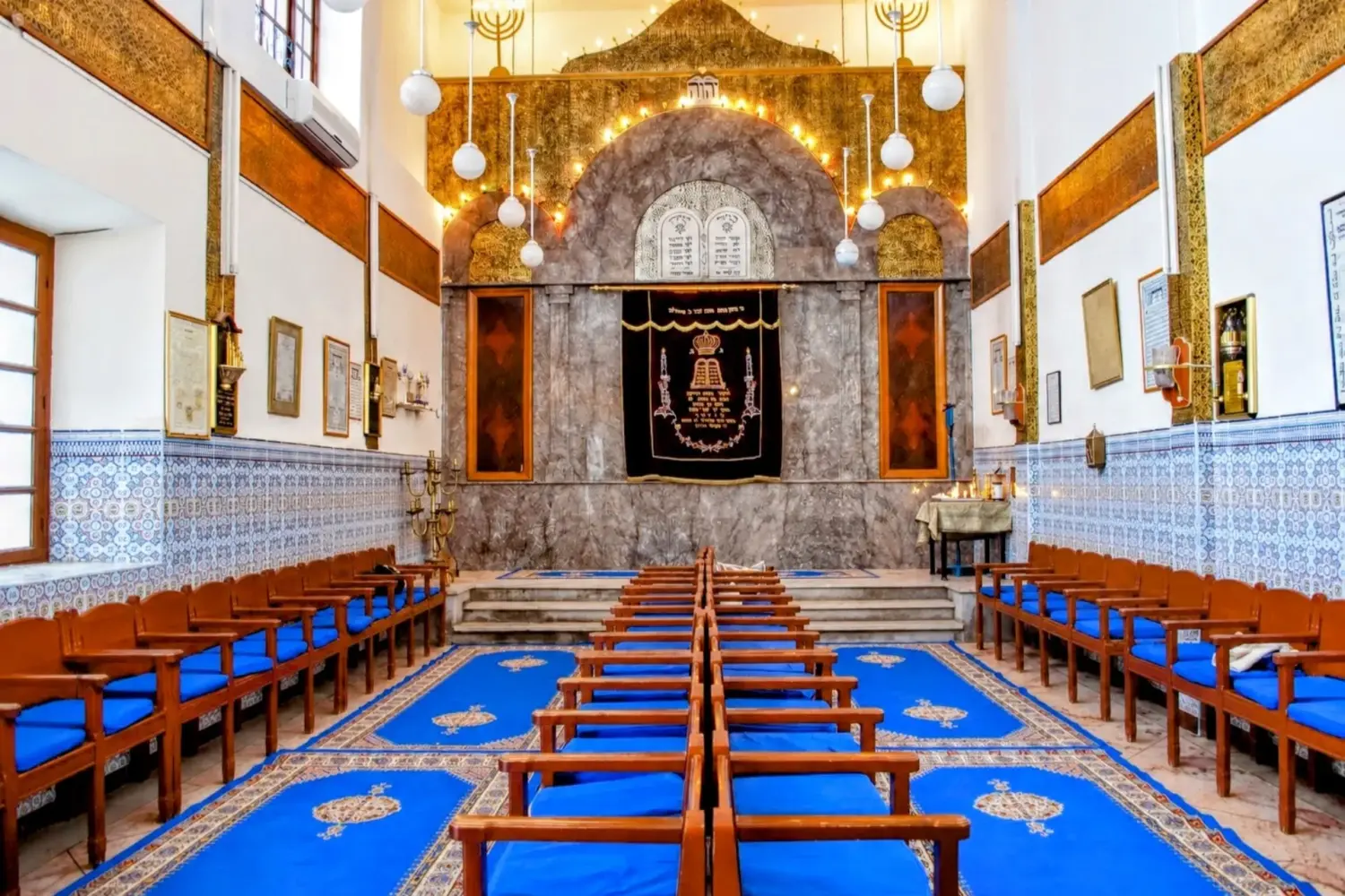 Historic Jewish synagogue interior in Marrakech featuring blue decorations and Hebrew inscriptions during 14 Day Jewish Heritage Tour in Morocco from Marrakech