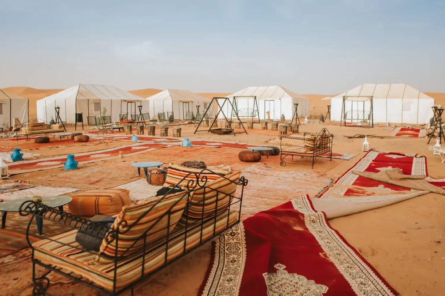 luxury desert camp in the Merzouga Sahara with tents and seating area