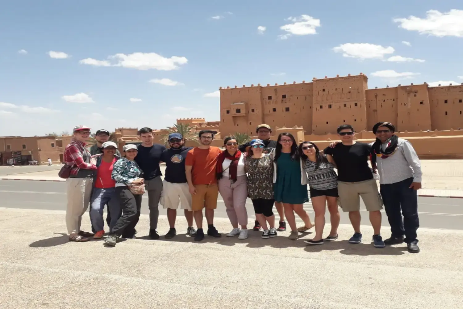 group of travelers standing in the Merzouga desert