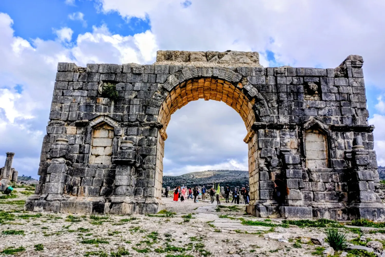 Roman arch gate at Volubilis Morocco on Fes to Meknes Day Trip