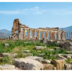 Ancient Roman ruins of Volubilis surrounded by green hills in Morocco
