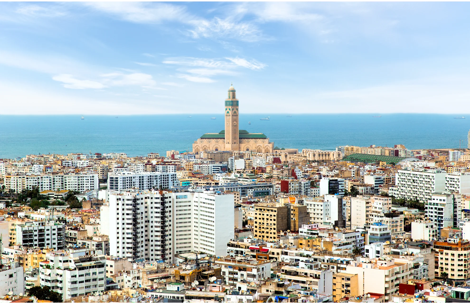 Casablanca city skyline and Hassan II Mosque Morocco for Is It Better to Travel Morocco With a Private Tour or Independently?