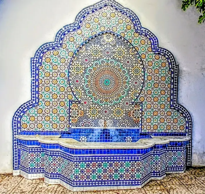Colorful Moroccan zellige fountain in Chefchaouen on a Day Trip from Fes to Chefchaouen
