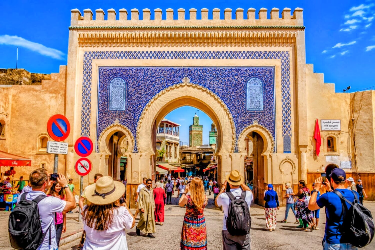 Tourists taking photos at Bab Boujloud, the famous blue gate of Fes Medina during 6 Day Casablanca to Marrakech Discovery Tour