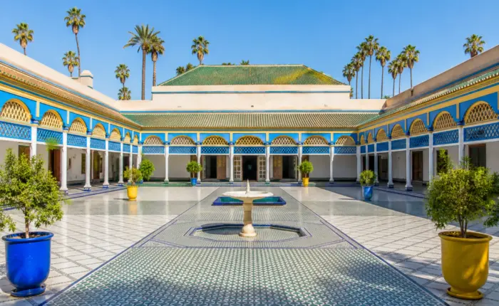 Grand courtyard of Bahia Palace in Marrakech with traditional Moroccan architecture.