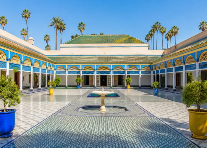 Grand courtyard of Bahia Palace in Marrakech with traditional Moroccan architecture.