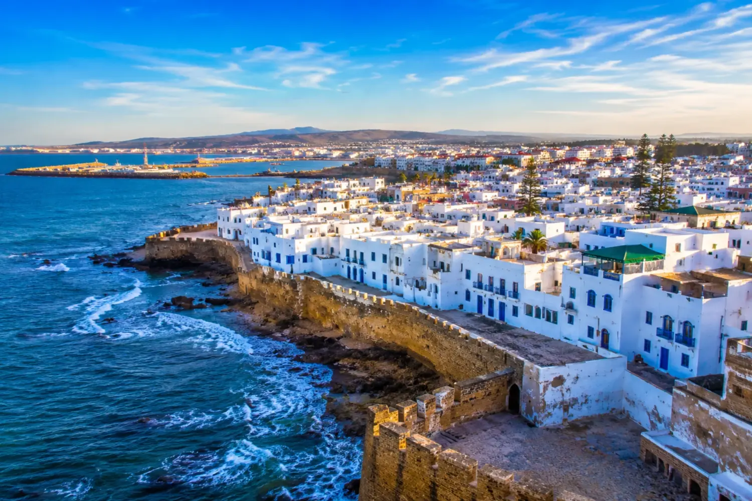 5 Day Tangier to Casablanca Private Tour featuring the coastal city of Asilah with its whitewashed medina, historic walls, and Atlantic Ocean views