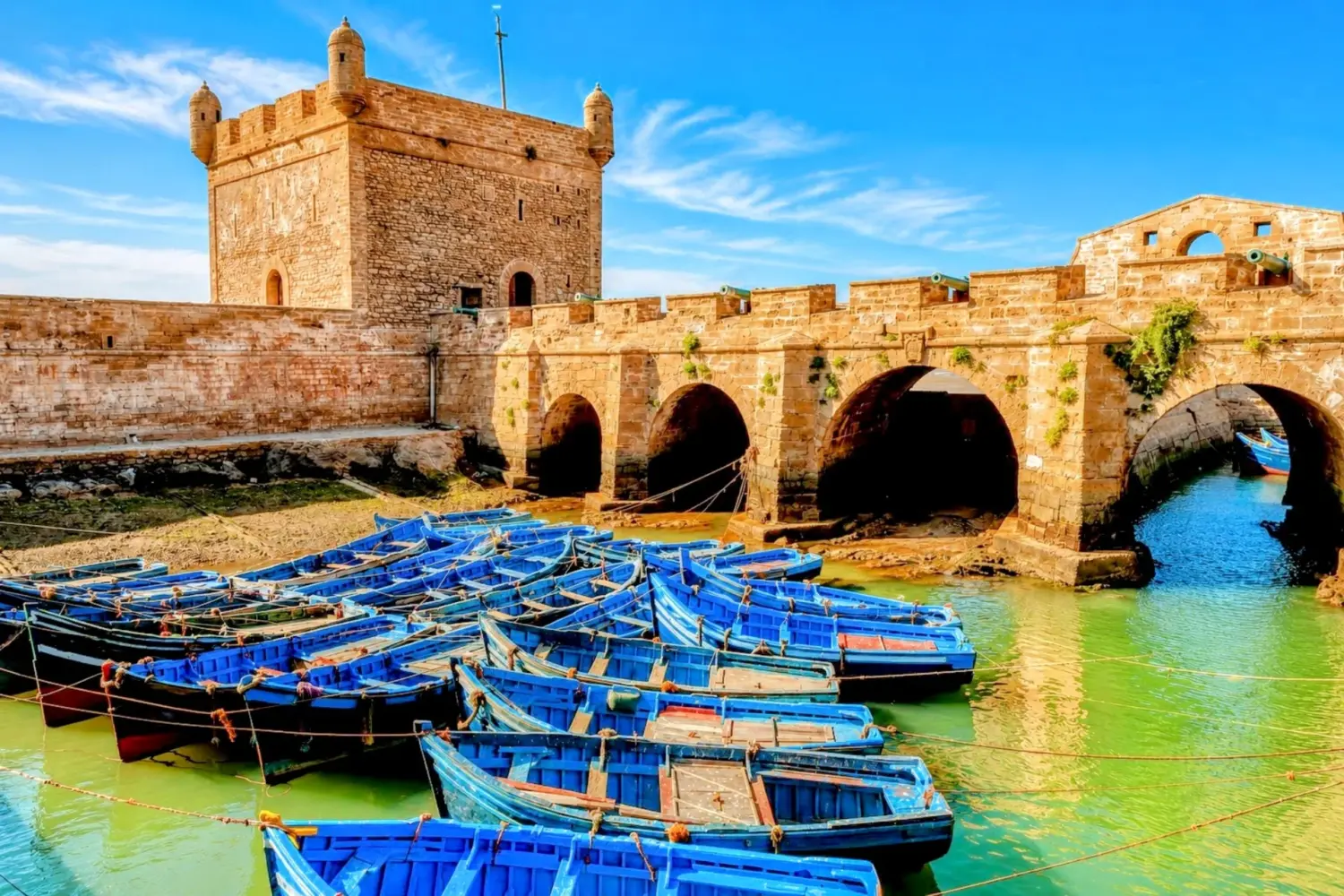 Traditional blue fishing boats in the historic harbor of Essaouira, Morocco.
