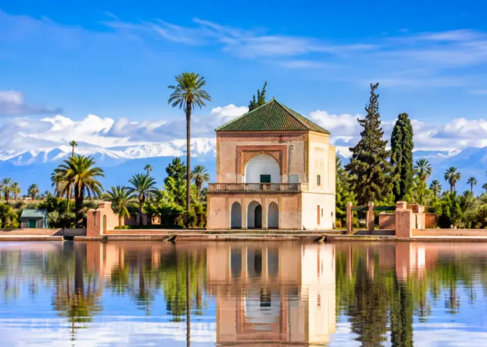 Menara Garden pavilion with reflecting pool and Atlas Mountains in Marrakech