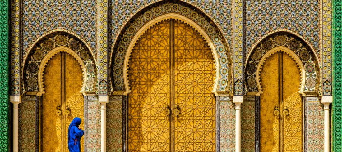 Royal Palace Gate in Fes, featuring magnificent golden doors and traditional Moroccan architecture.