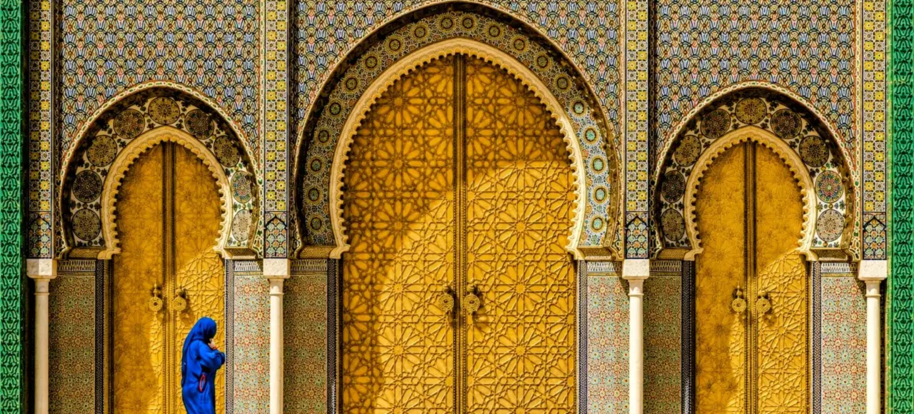 Royal Palace Gate in Fes, featuring magnificent golden doors and traditional Moroccan architecture.